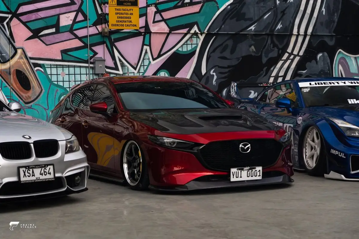 Red Mild Mazda photographed outside the workshop